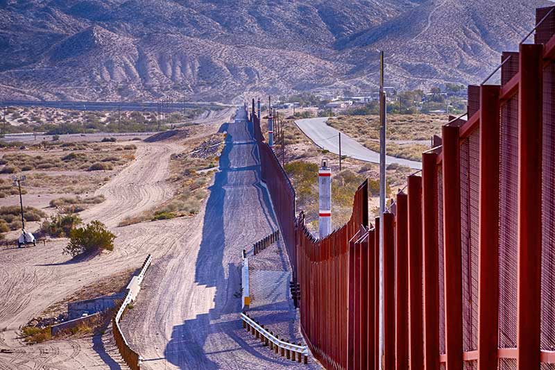 El Paso, Texas / USA Border wall between USA and Mexico running thru the desert.